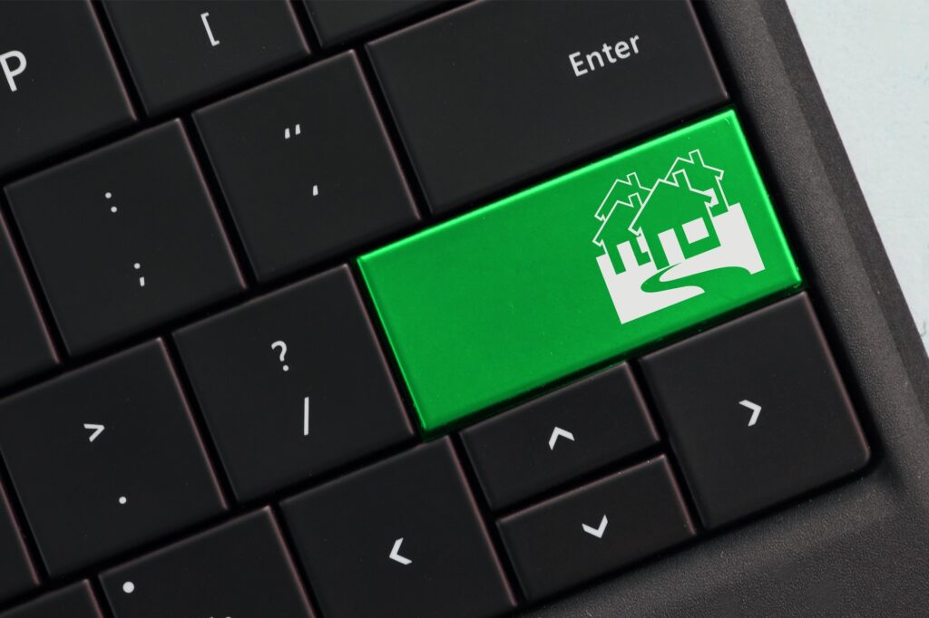 Concept - Computer Keyboard with green key housing market homes online real estate search browsing